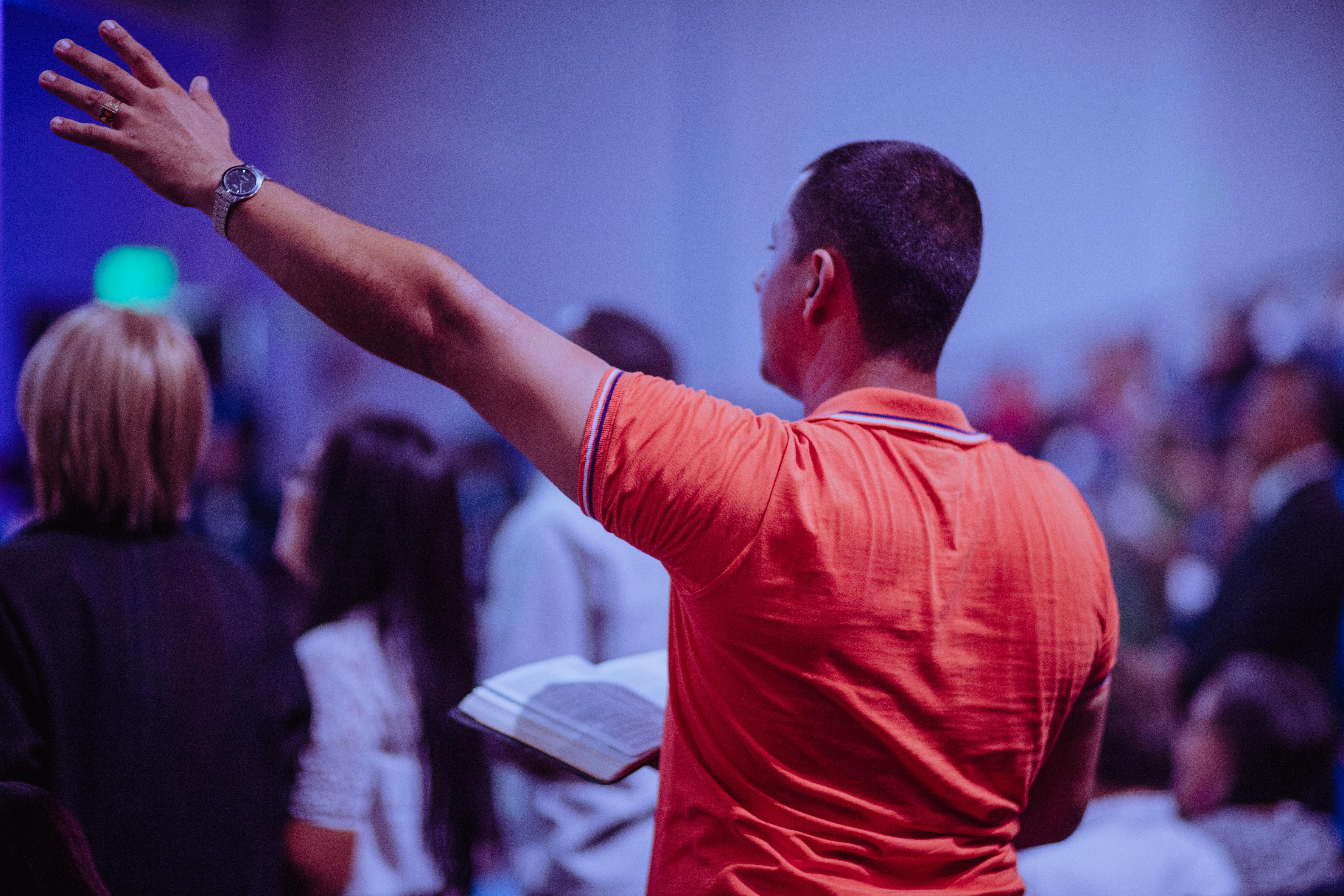 A man lifts his hands during worship